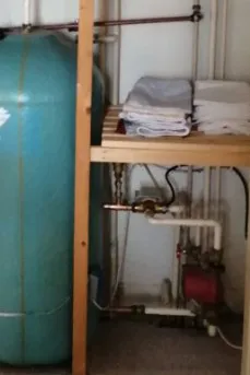 Central heating repairs 3 Hot water cylinder and pump in an airing cupboard