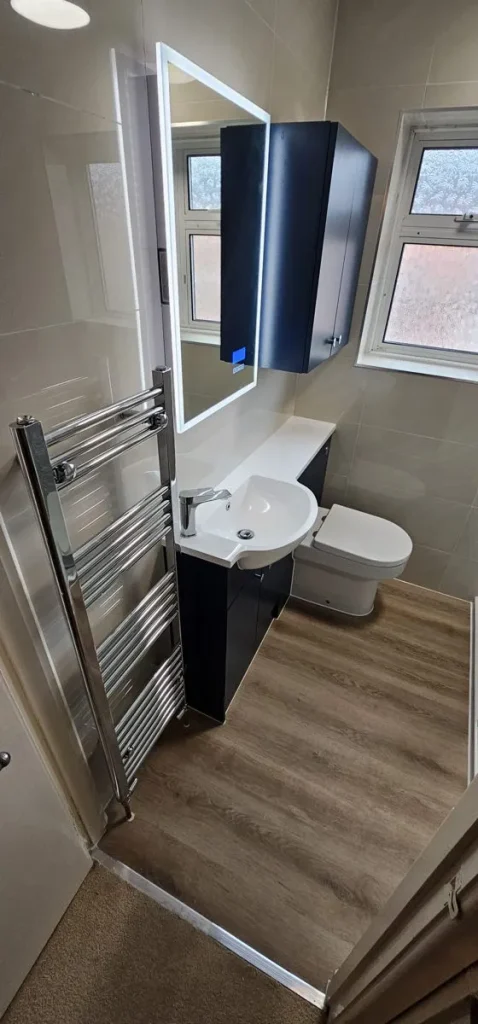 Navy fitted vanity and WC unit with LED mirror and wall cabinet